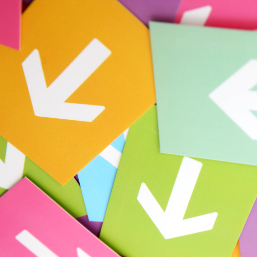 A pile of coloured sheets with arrows pointing in different directions