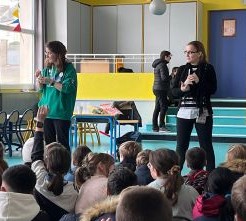 Two teachers in front of a group of students