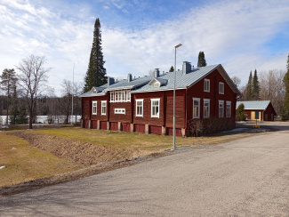 The Hyytiälä Forest Station: a wooden building painted red with white windows and a grey roof