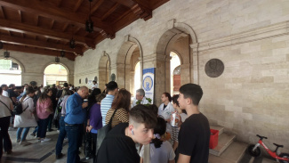 people in front of stands at a science exhibition