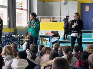 Two teachers in front of a group of students