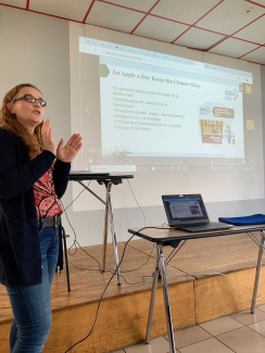 A teacher in front of a screen during a presentation